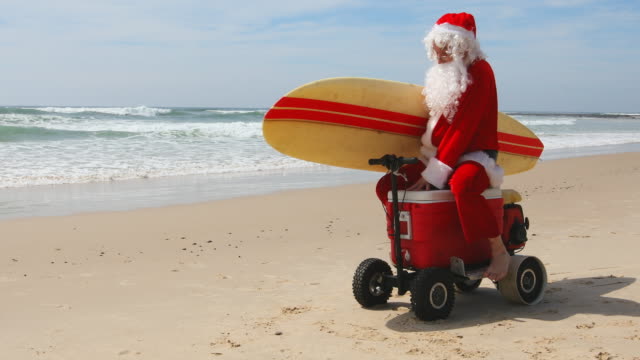 australian-christmas-santa-claus-pretending-to-ride-a-motorised-esky-video-id847015812